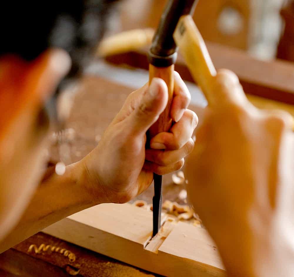 Carpenter making mortise and tenon joint