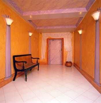 False marble columns under up-lighters, marbled ceiling and tromp l'oeil curtain drapes all add to the charm of this entrance hall.