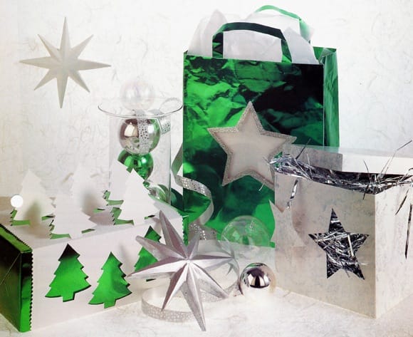 Sparkling Christmas wrap. Wrapped in dazzling Christmas colours of green and silver these presents look a million dollars, but will only take a little time and a few cents to produce. Transform plain carrier bags and boxes into expensive looking gifts everyone will want to unwrap.